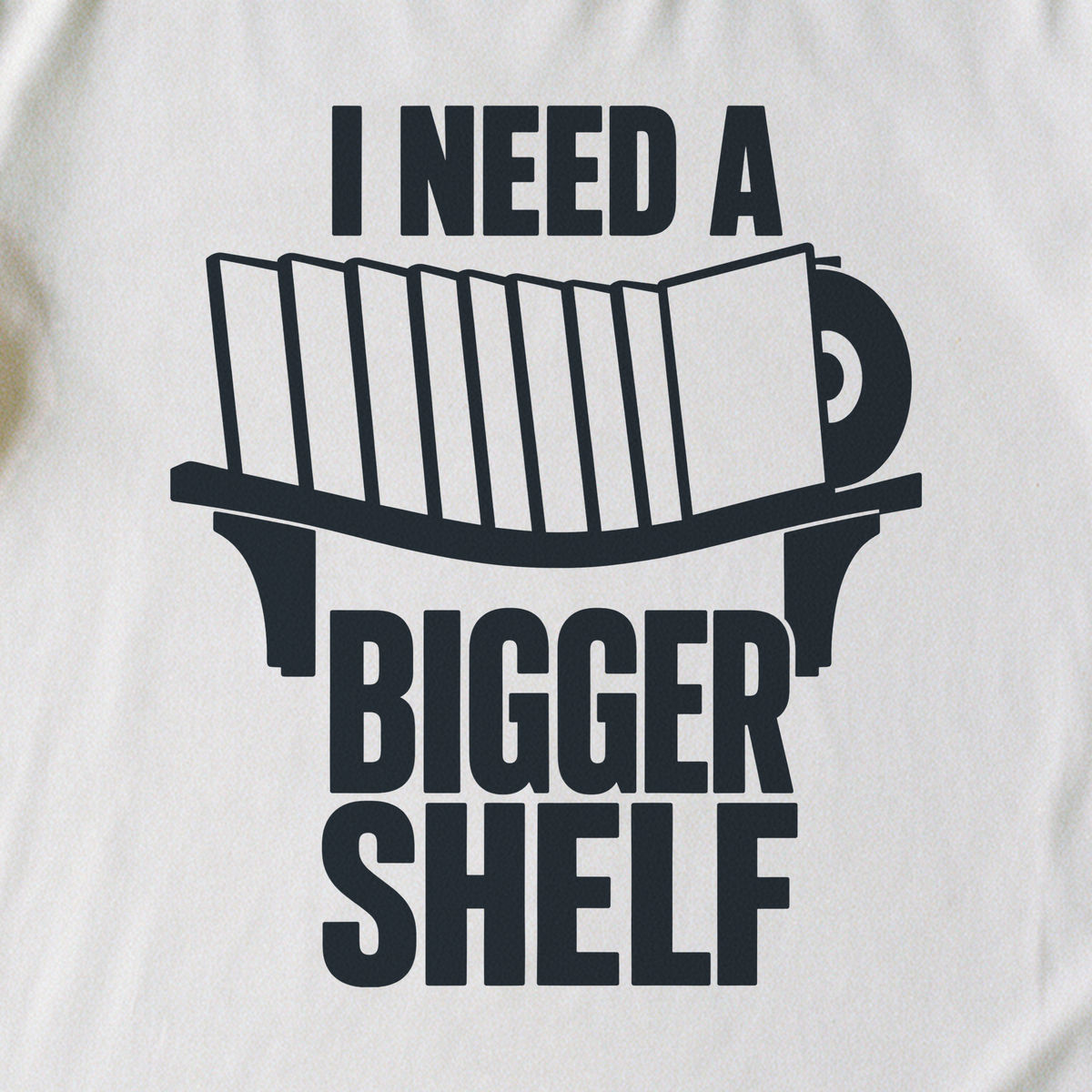 I Need a Bigger Shelf Tee - White close-up print
