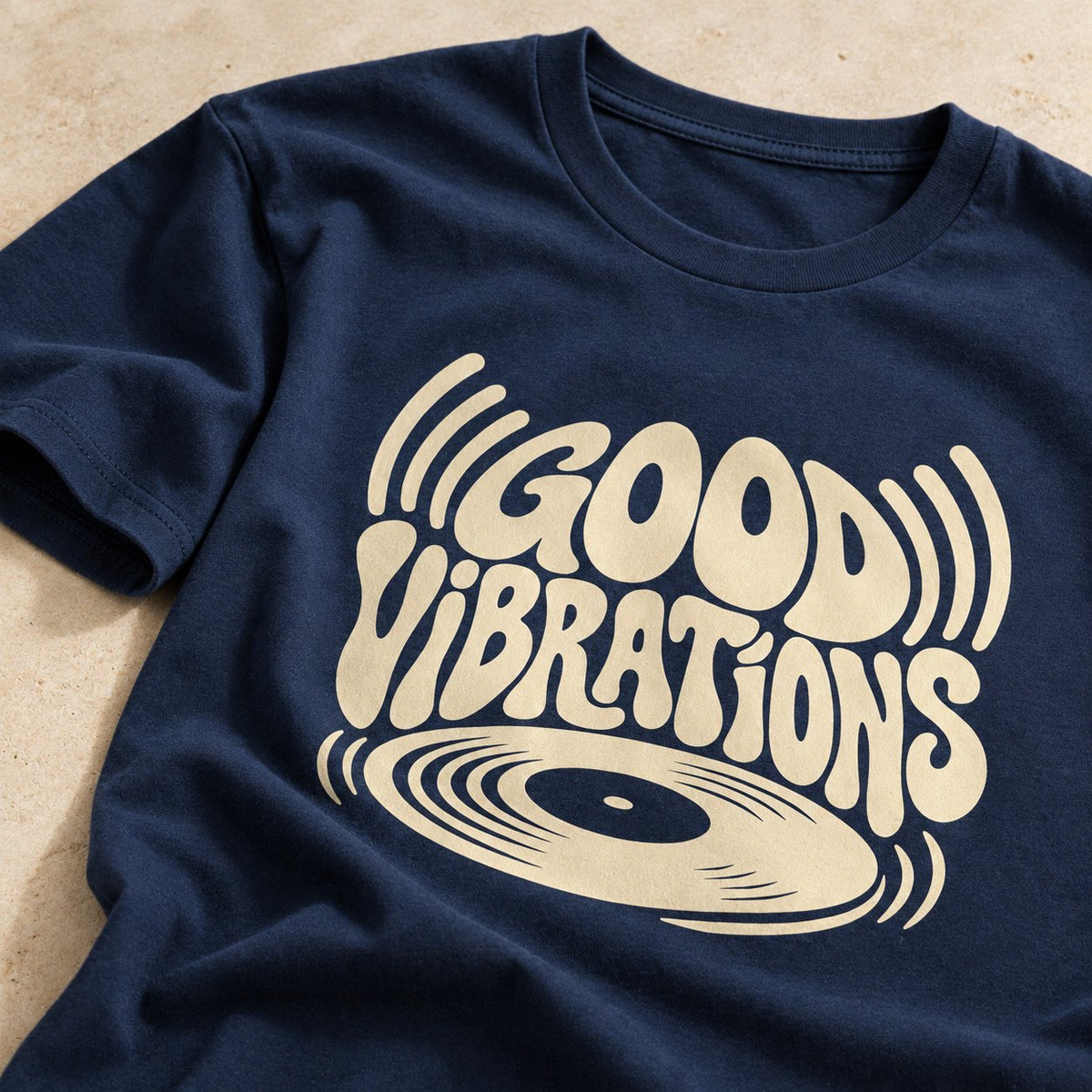Close-up of a navy Good Vibrations tee with a cream print